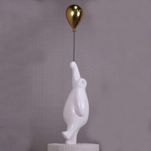 statuette ours blanc avec ballon en or qui s'envole